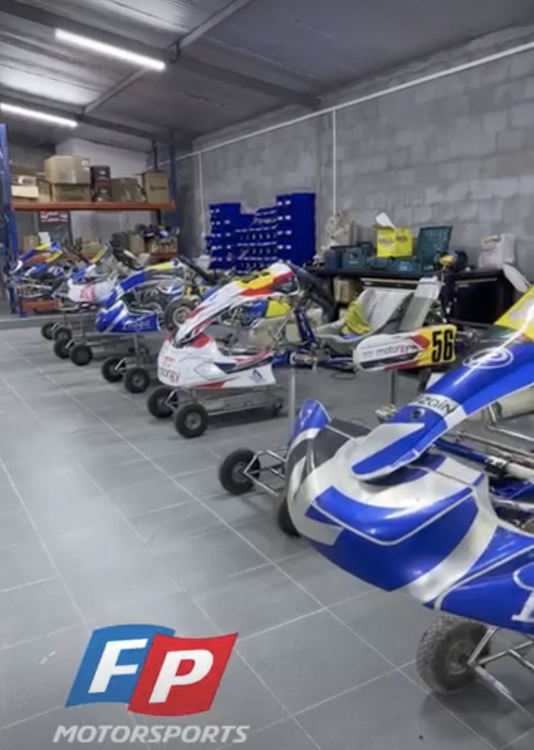 Indoor kart storage at FP Motorsports — karts on stands in the warehouse